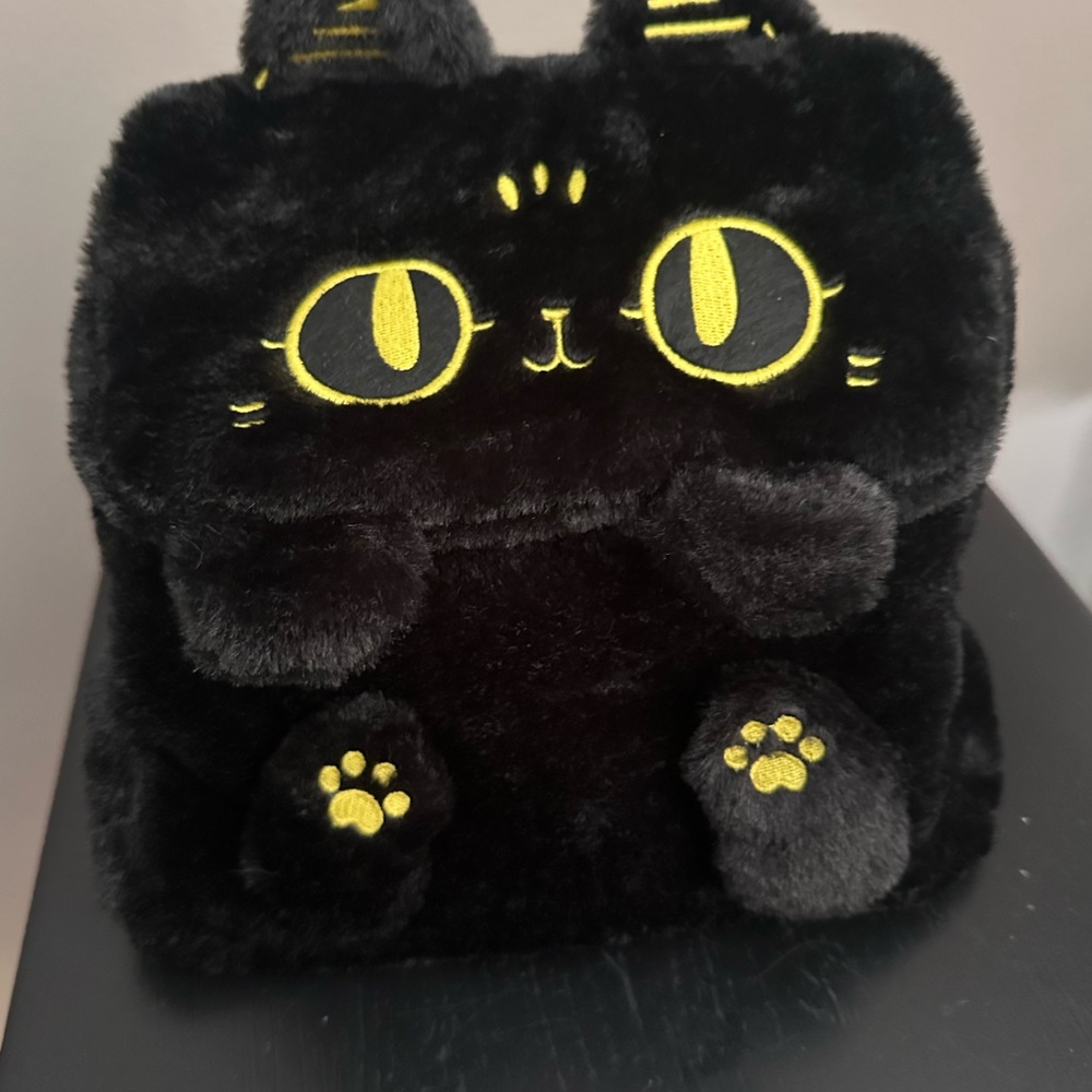 Plush Black Cat Backpack with Yellow Accents. Versatile straps
